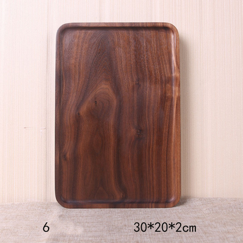 A collection of square and rectangular walnut wooden plates in various sizes, with a hand-painted texture, displayed on a beige background. Earthy tones and whole wood. Calm and minimalist interior atmosphere.