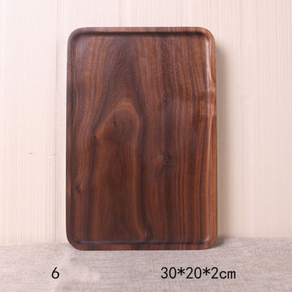 A collection of square and rectangular walnut wooden plates in various sizes, with a hand-painted texture, displayed on a beige background. Earthy tones and whole wood. Calm and minimalist interior atmosphere.