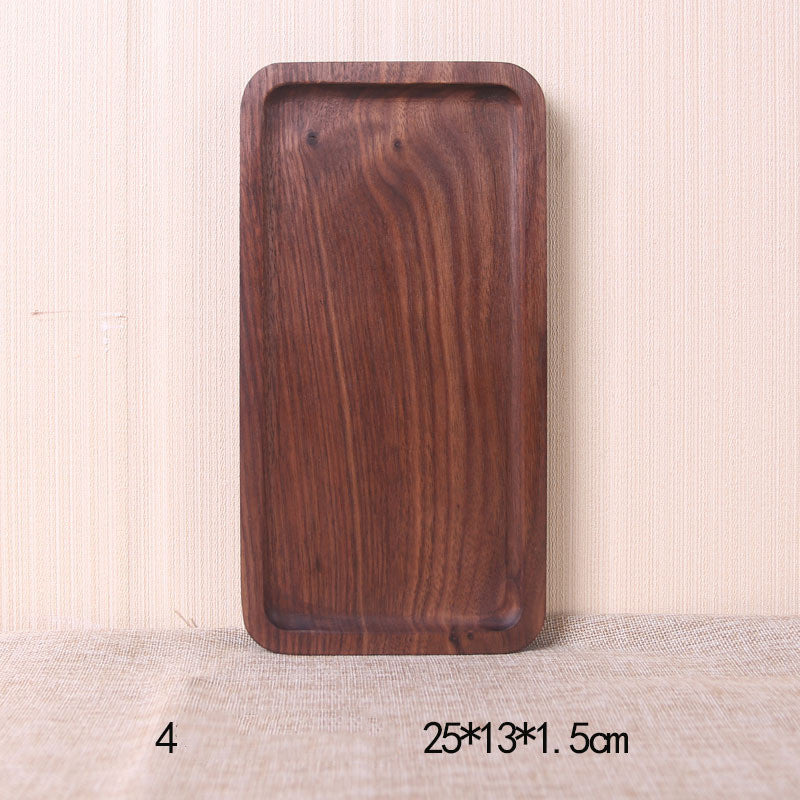 A collection of square and rectangular walnut wooden plates in various sizes, with a hand-painted texture, displayed on a beige background. Earthy tones and whole wood. Calm and minimalist interior atmosphere.