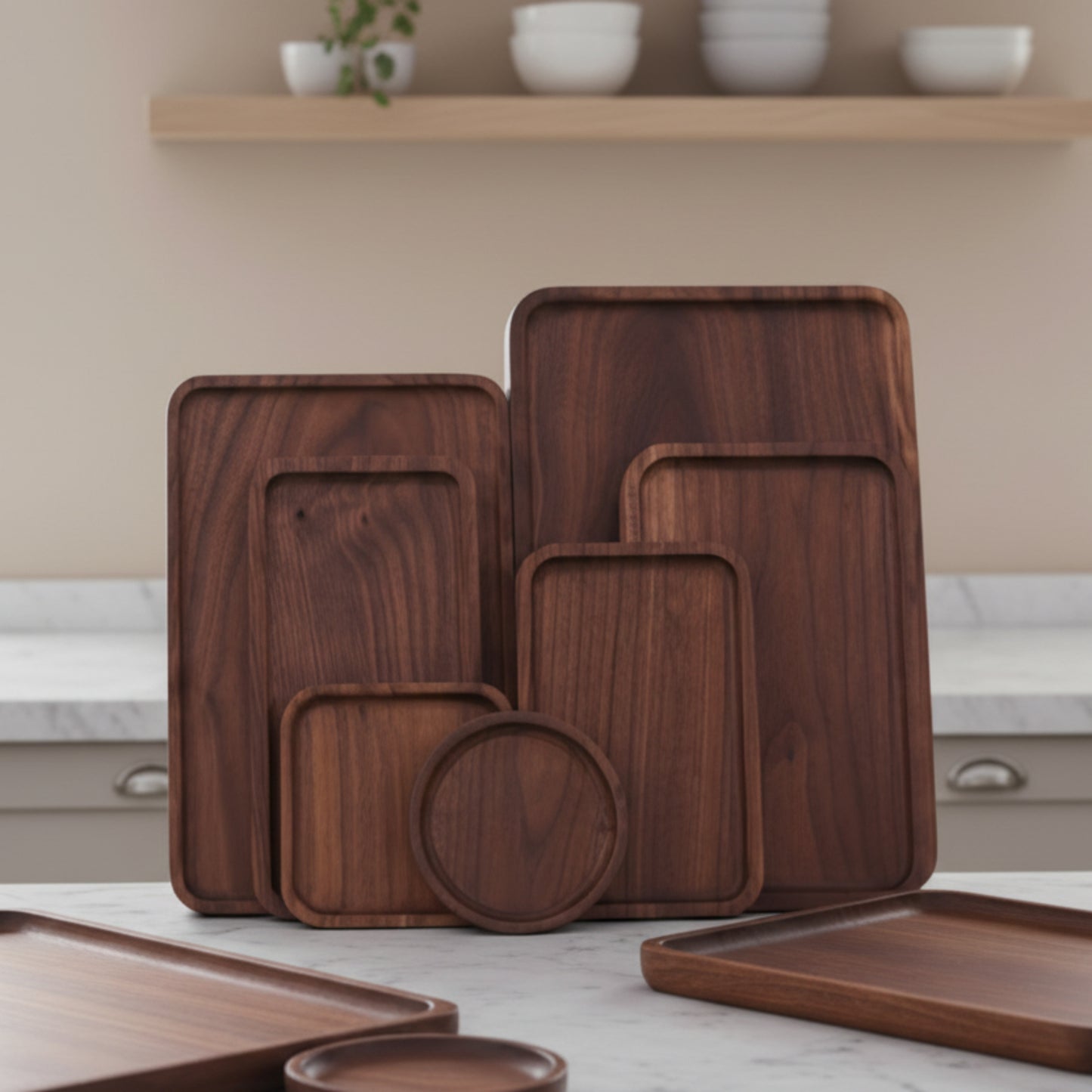 Set of wooden trays of different sizes on a marble grey kitchen shelf. Beige and warm background. Earthy tones and whole wood. Calm, peaceful and minimalist interior atmosphere. 