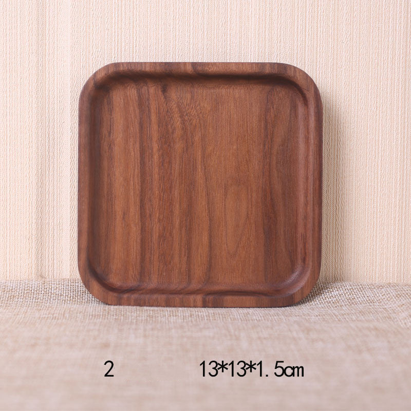A collection of square and rectangular walnut wooden plates in various sizes, with a hand-painted texture, displayed on a beige background. Earthy tones and whole wood. Calm and minimalist interior atmosphere.