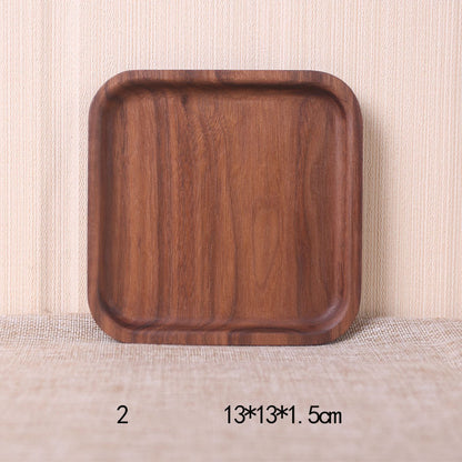 A collection of square and rectangular walnut wooden plates in various sizes, with a hand-painted texture, displayed on a beige background. Earthy tones and whole wood. Calm and minimalist interior atmosphere.