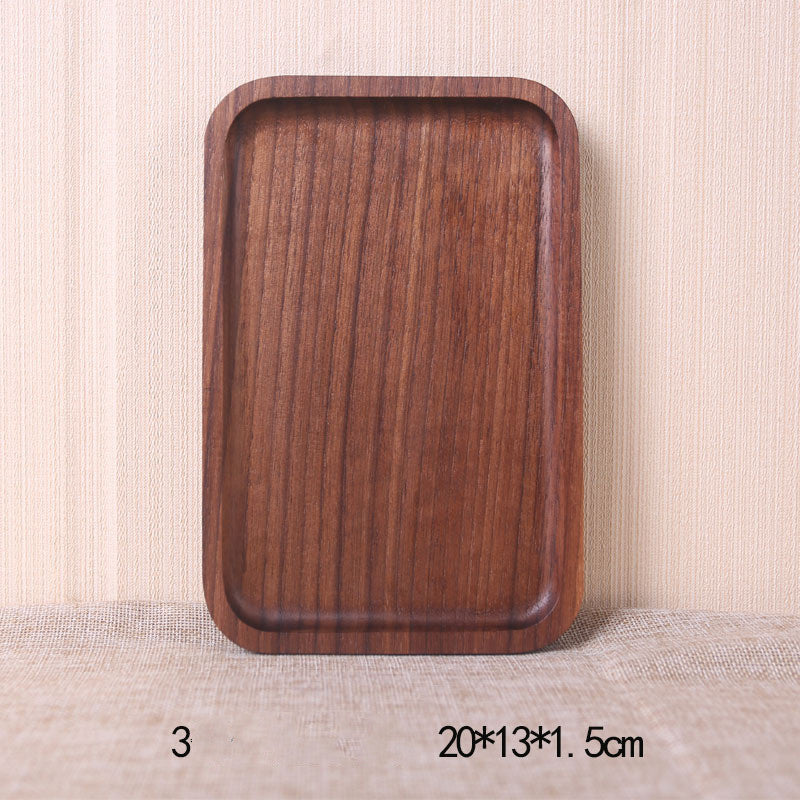 A collection of square and rectangular walnut wooden plates in various sizes, with a hand-painted texture, displayed on a beige background. Earthy tones and whole wood. Calm and minimalist interior atmosphere.