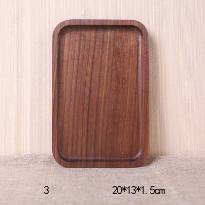 A collection of square and rectangular walnut wooden plates in various sizes, with a hand-painted texture, displayed on a beige background. Earthy tones and whole wood. Calm and minimalist interior atmosphere.