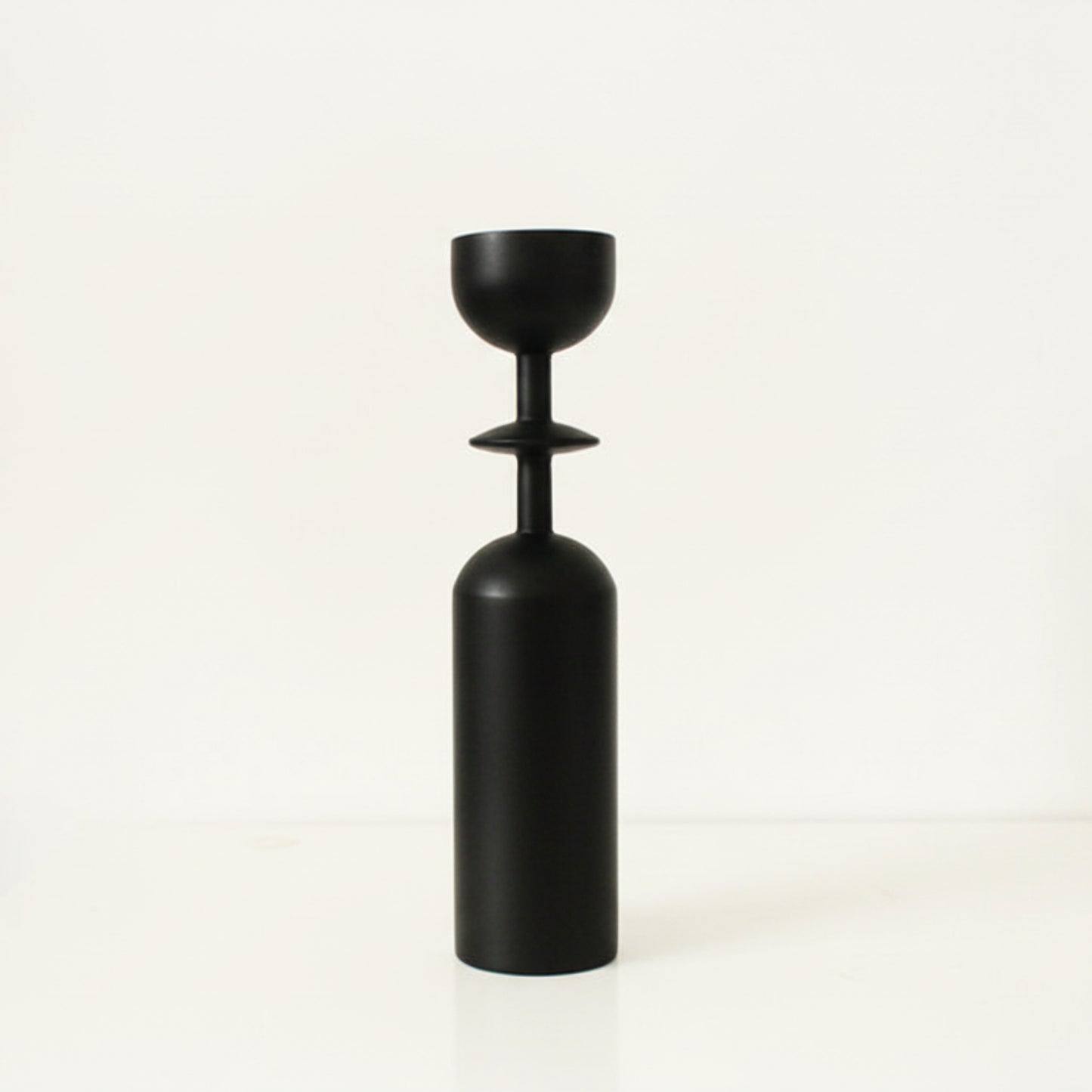 Black unique wooden candle holder on a white background. Earthy and natural home decor. 