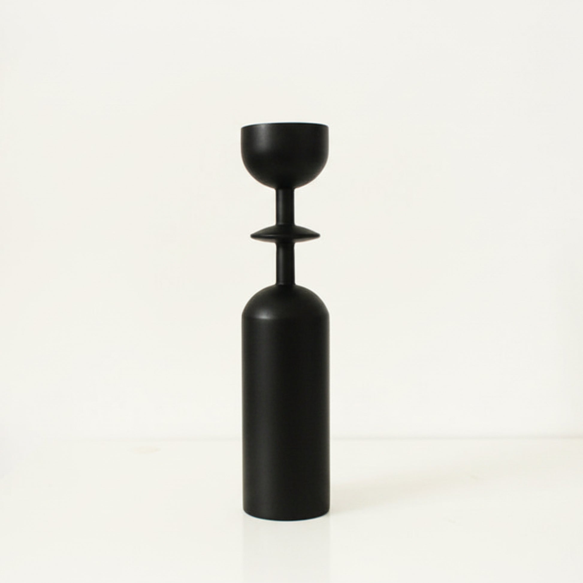 Black unique wooden candle holder on a white background. Earthy and natural home decor. 