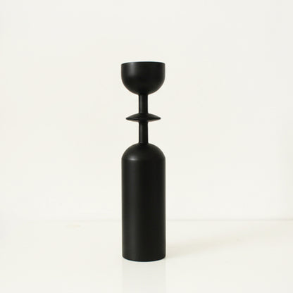 Black unique wooden candle holder on a white background. Earthy and natural home decor. 