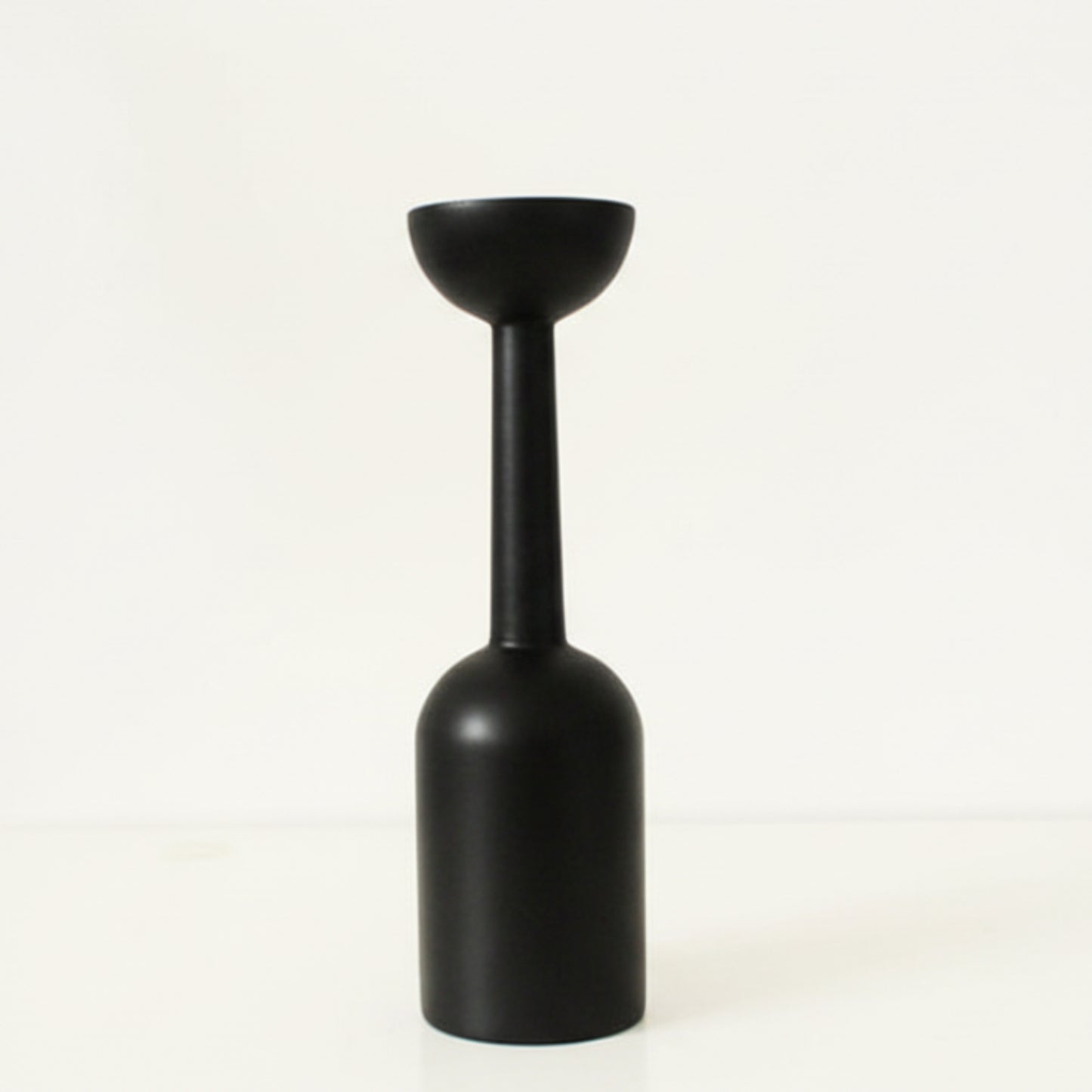 Black unique wooden candle holder on a white background. Earthy and natural home decor. 