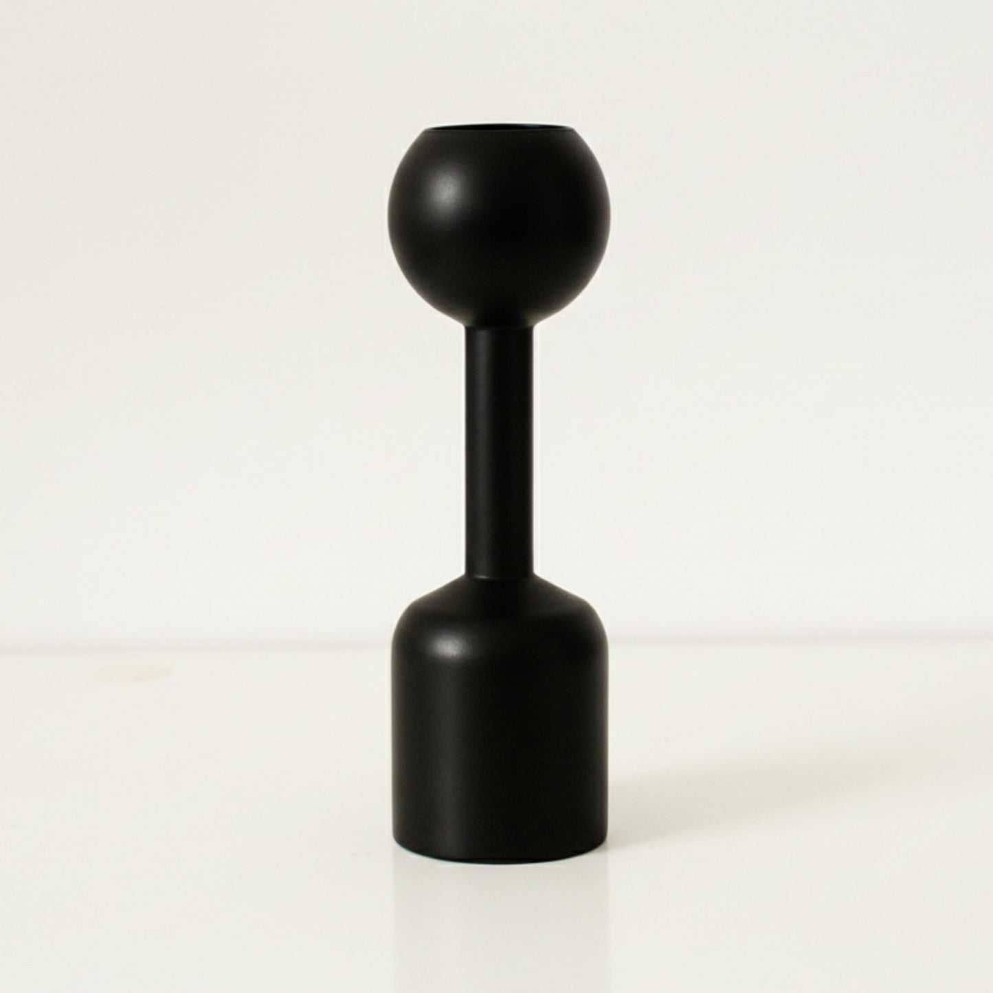 Black unique wooden candle holder on a white background. Earthy and natural home decor. 