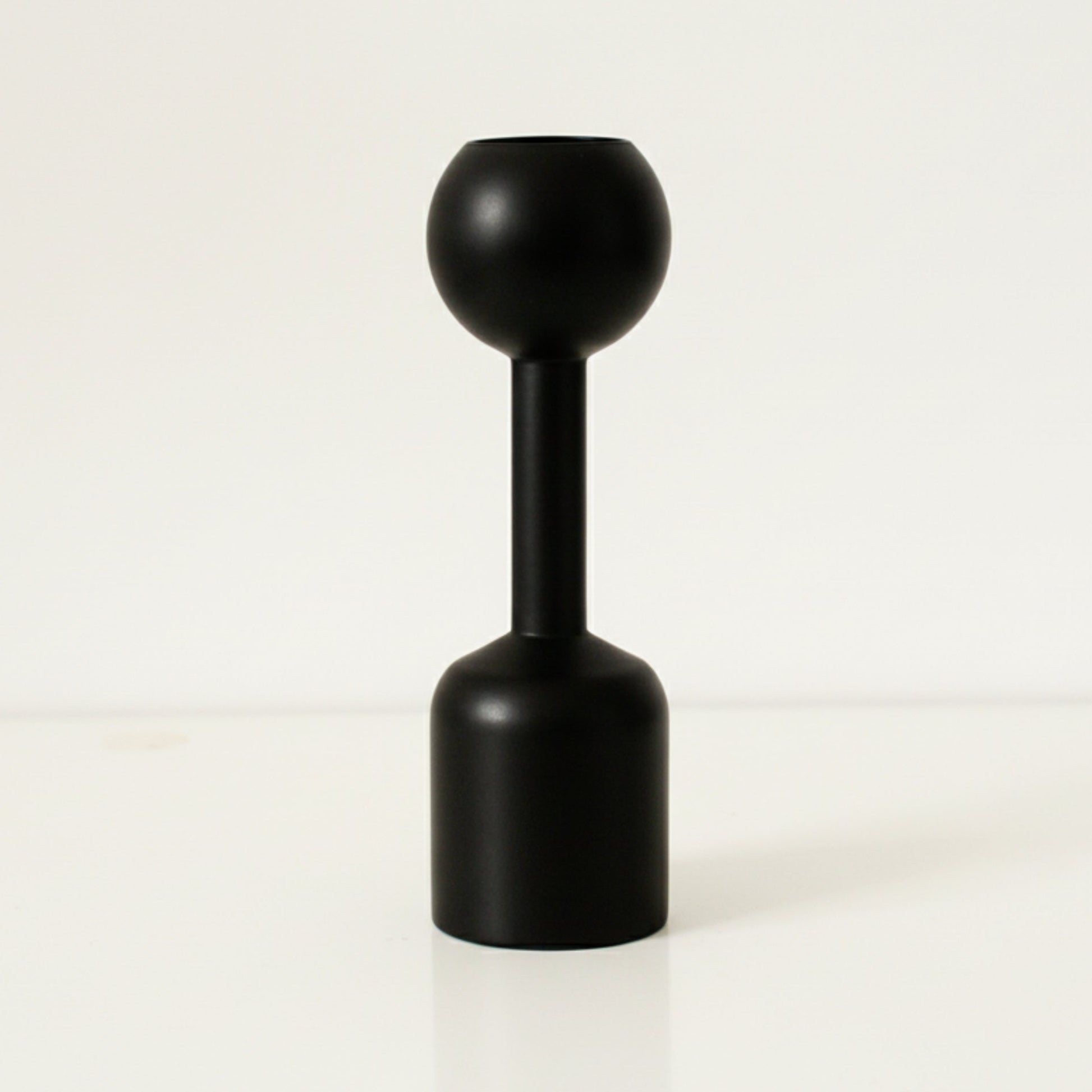 Black unique wooden candle holder on a white background. Earthy and natural home decor. 