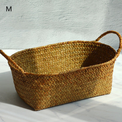 Woven basket with handles on a light background and on a light grey marble surface. Size M. 
Scandinavian decor inspired by simplicity and warm tones. Perfect for creating calm, minimalist interiors. Earthy tones for storage. 
