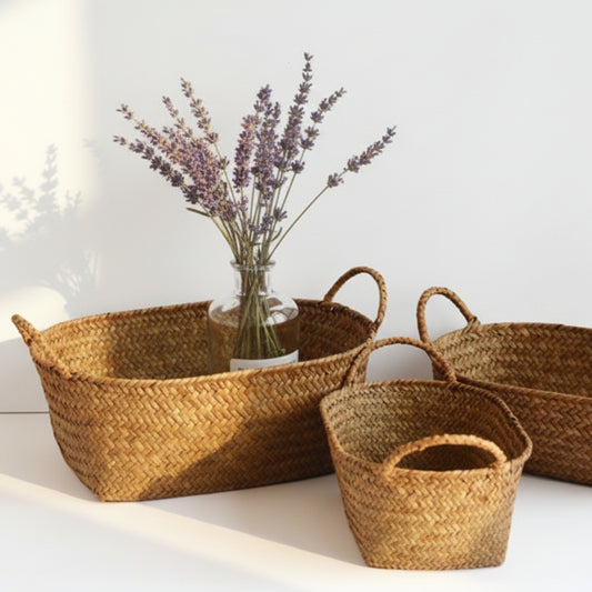 Three woven baskets with a vase of lavender on a white surface