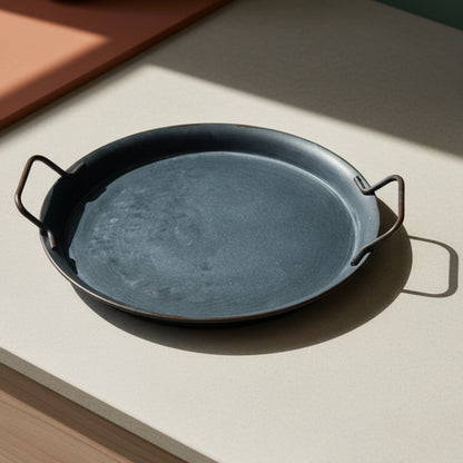 Wrought iron tray with handles on a warm background. Minimalist black decor centerpiece. 